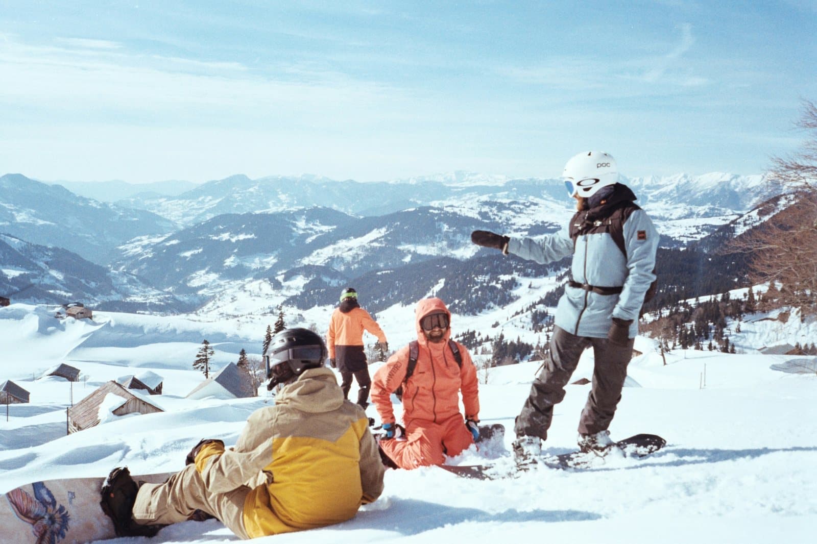Friends taking a break on the snow with their boards